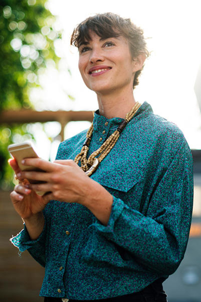 Women smiling with mobile phone in her hand